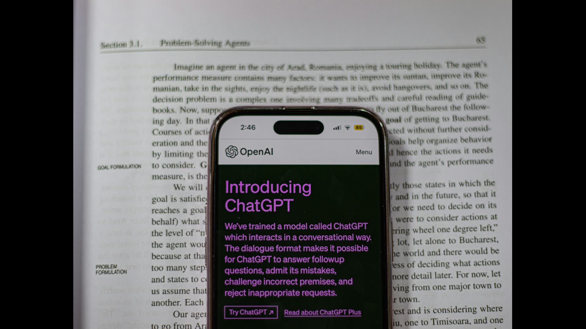 Cell phone sitting on top of open book